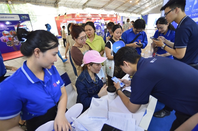 Festival-goers can get detailed and comprehensible information about products and services of participating banks by touring the festival. Photo: Quang Dinh / Tuoi Tre
