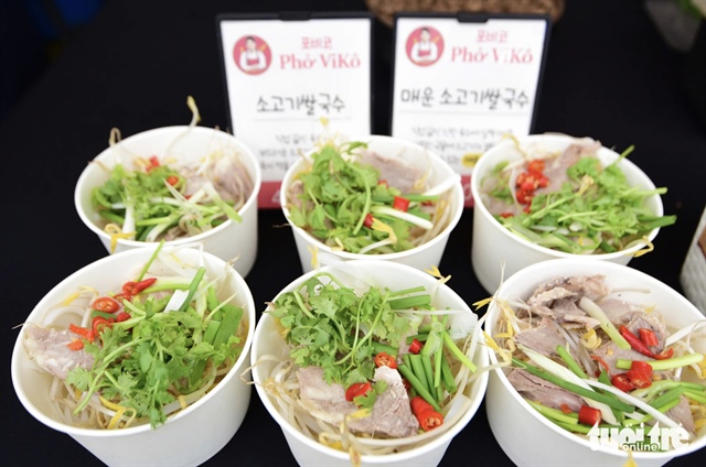 Visitors wait for a bowl of phở at the stall of Phở Atiso