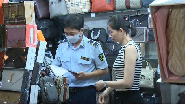 A market surveillance officer checks a stall displaying watches and sunglasses at Ben Thanh Market in District 1, Ho Chi Minh City, October 31, 2024. Photo: Supplied