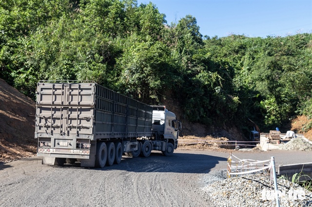 A section of National Highway 15D is being widened to facilitate the transport of coal from Laos to Quang Tri Province. Photo: Hoang Tao / Tuoi Tre