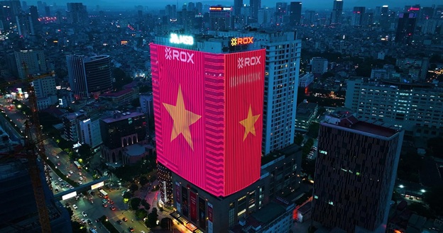 ROX Tower with a giant LED screen displaying the Vietnamese flag